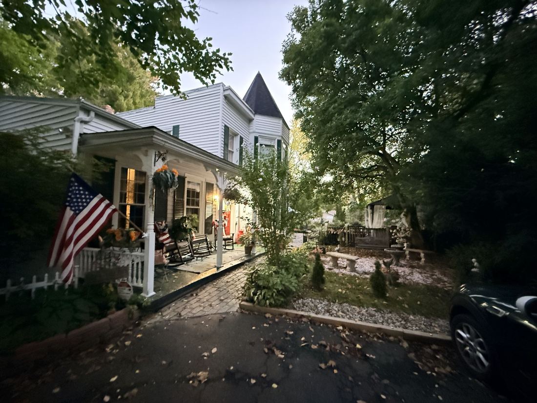 Albany, early morning. A Victorian porch with the flag out, before the drive east.