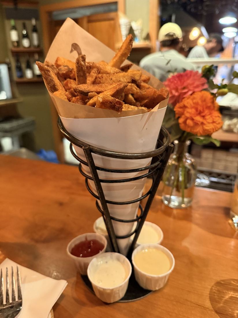 Fries, Portland. A paper cone of fries with five dipping sauces.