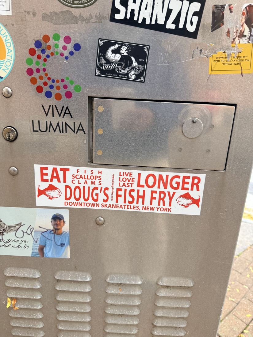 Skaneateles. Eat fish, live longer. A Doug's Fish Fry sticker downtown.