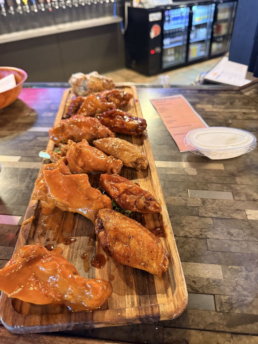 Wingnutz, Williamsville. A wing flight: a board of wings in a run of different sauces.
